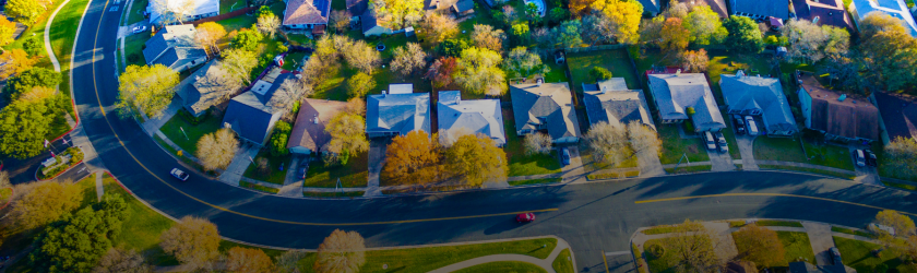 Banner image of an aerial view of houses in a neighborhood.