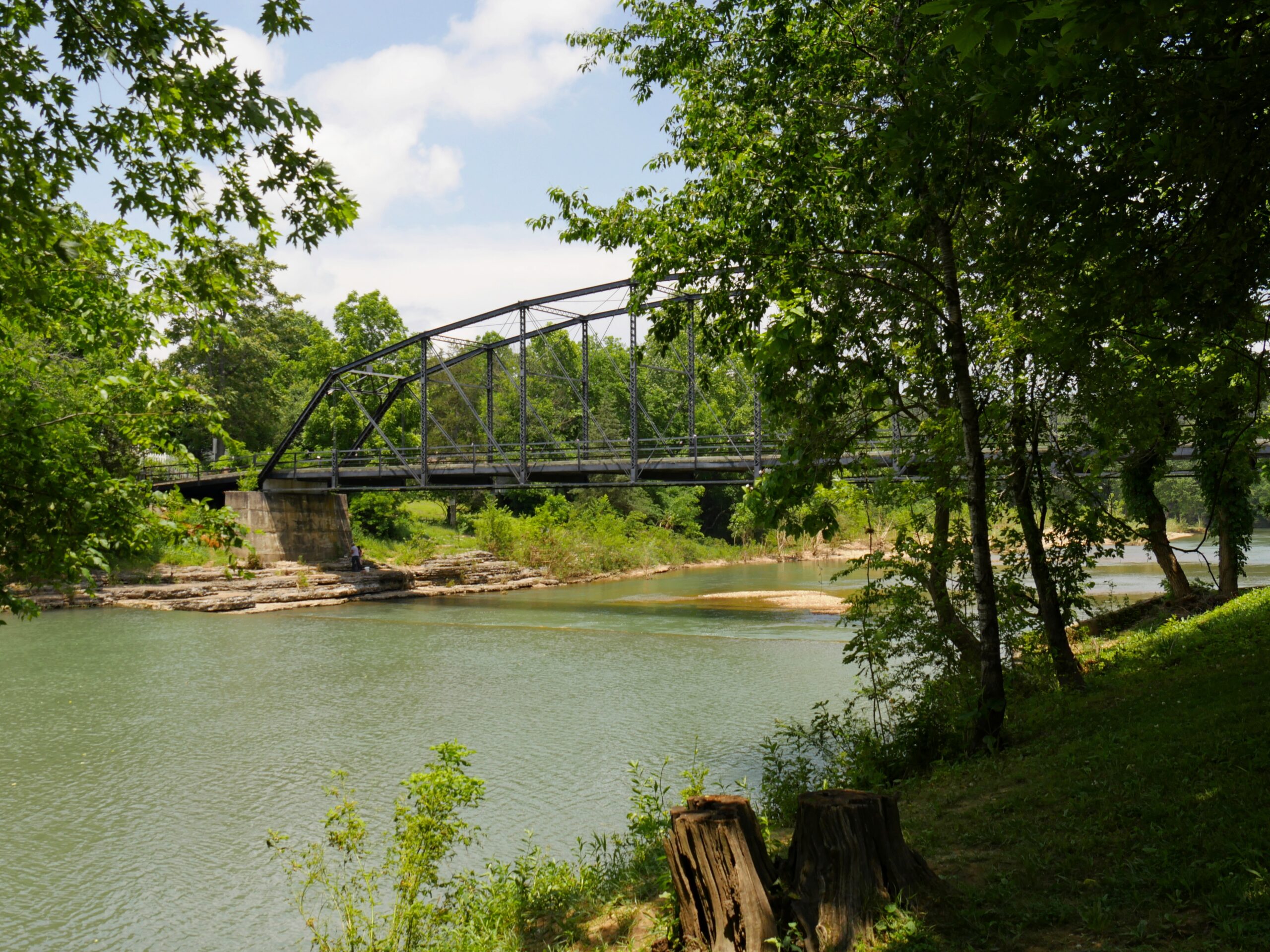 Old wooden bridge with steel railings at the War Eagle River in Rogers, Arkansas